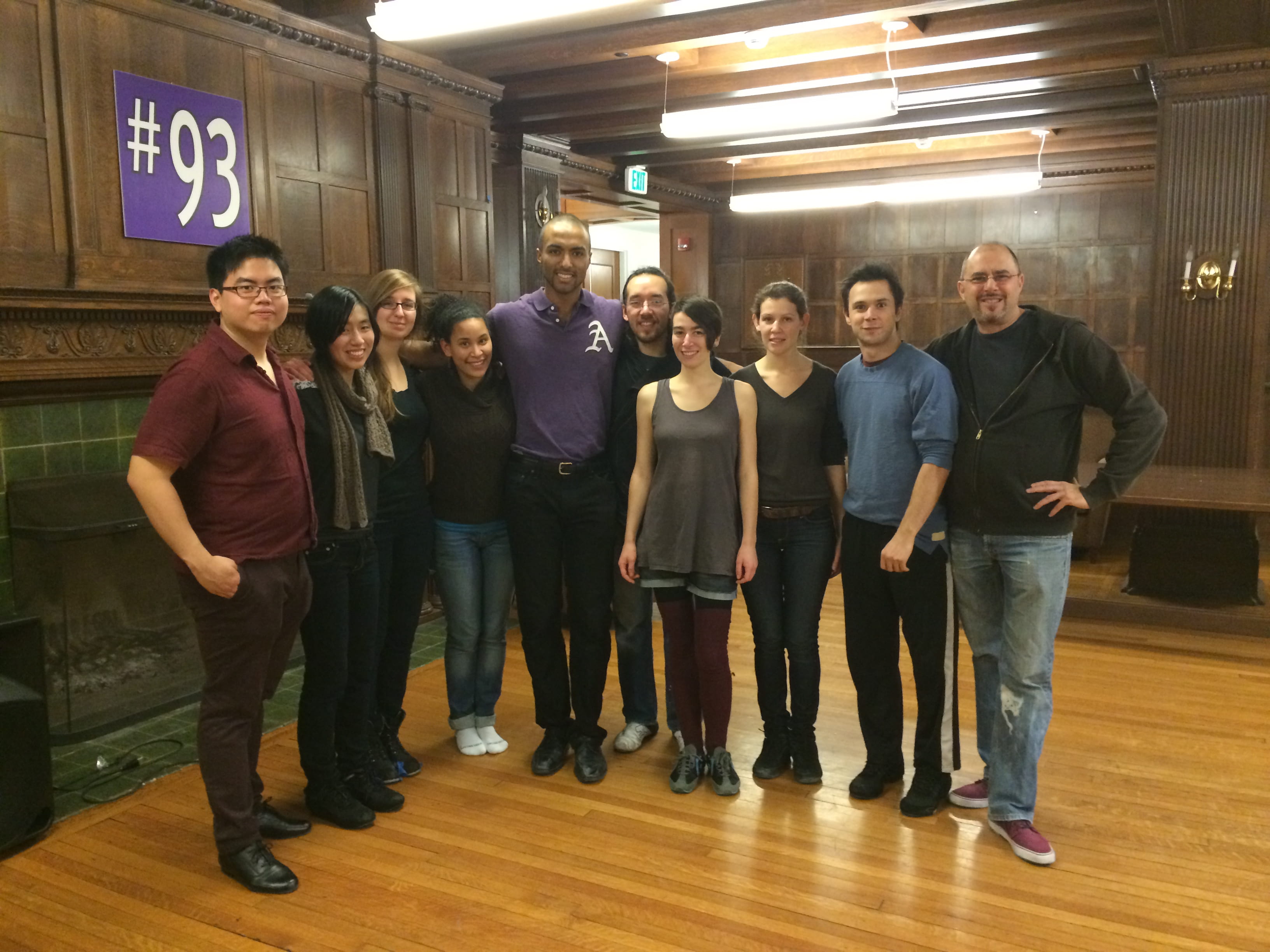 Club photo of Amherst Argentine Tango club. 10 people stand in a line facing the camera.