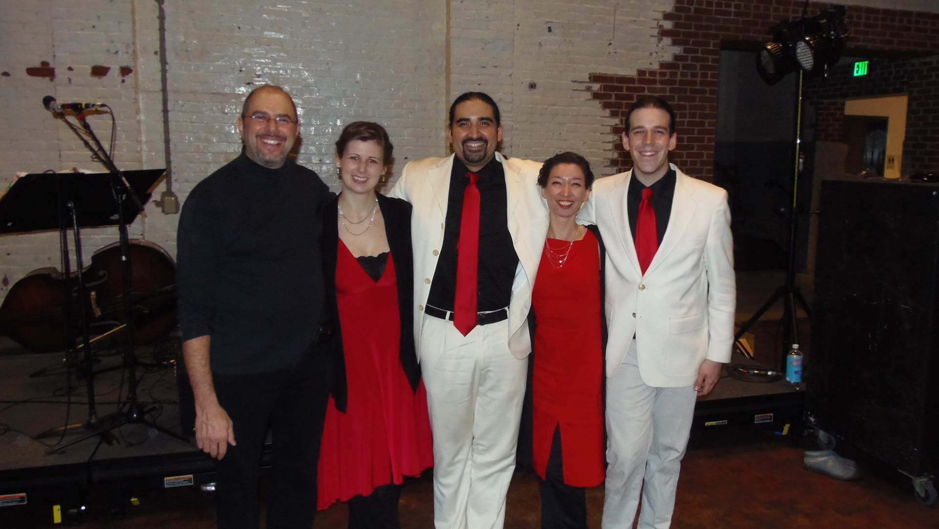 Daniel Trenner standing side by side with four tango musicians.
